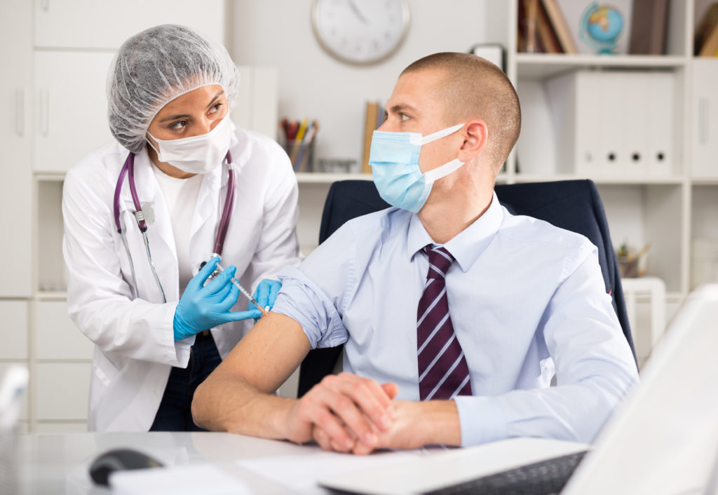 Senior Living Executive Staff Receiving Vaccine from Doctor/Nurse